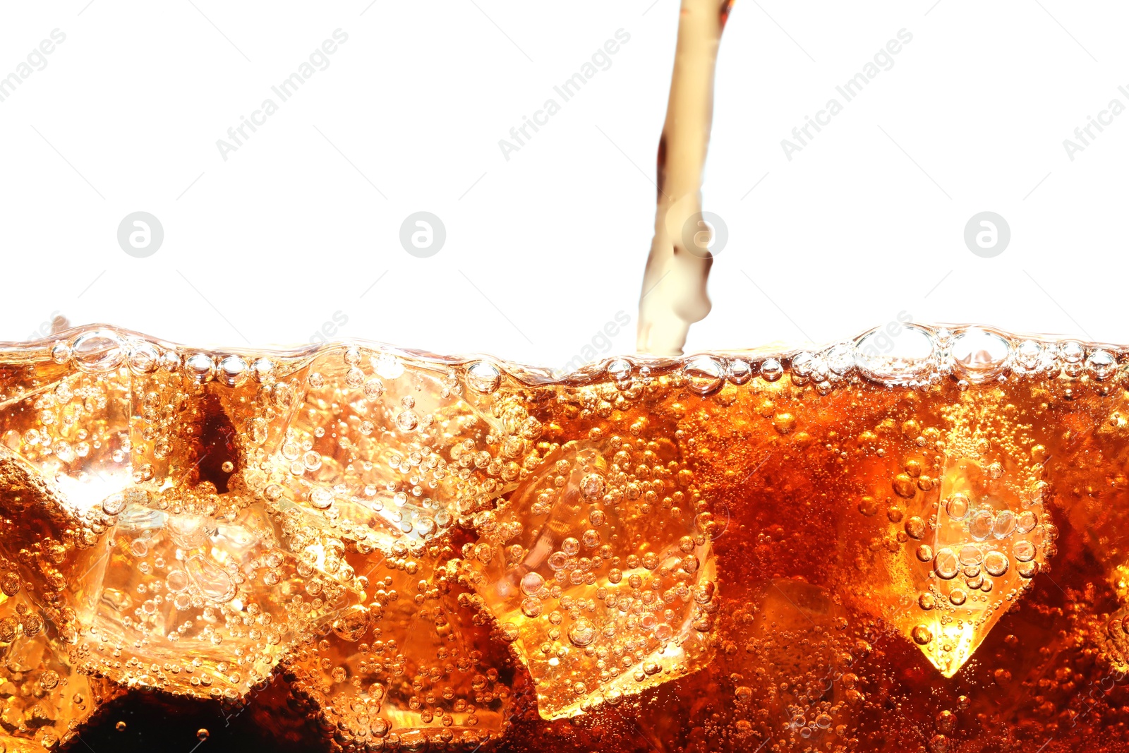 Photo of Pouring refreshing cola into glass with ice isolated on white
