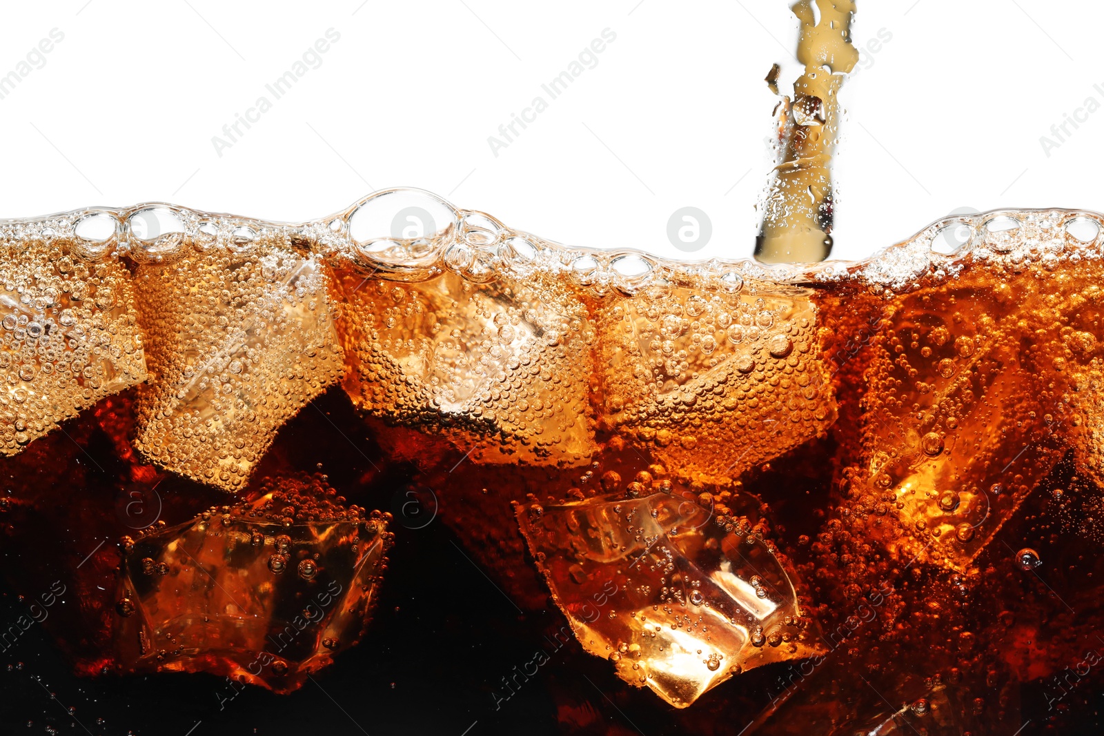 Pouring refreshing cola into glass with ice isolated on white Photo of Pouring refreshing cola into glass with ice isolated on white
