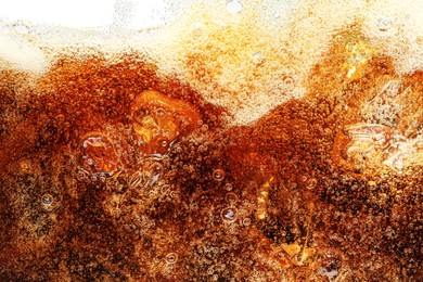 Photo of Fizzy cola with bubbles as background, macro view