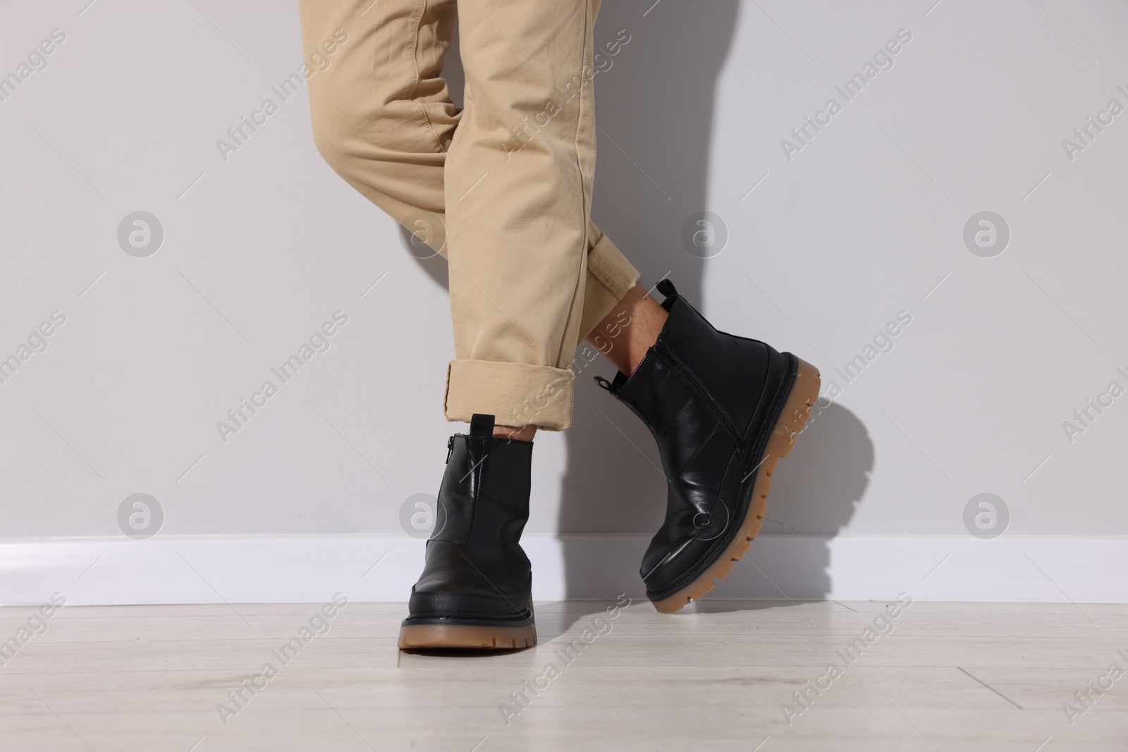 Photo of Man wearing pair of boots indoors, closeup