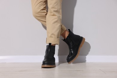 Photo of Man wearing pair of boots indoors, closeup