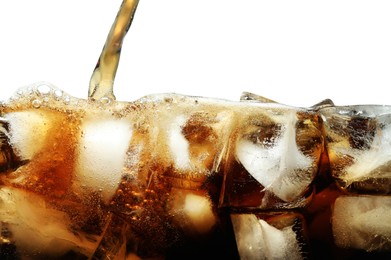 Photo of Pouring refreshing cola into glass with ice isolated on white