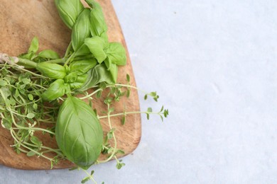Photo of Different fresh green herbs on light grey table, top view. Space for text