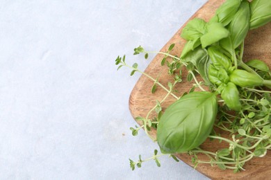 Photo of Different fresh green herbs on light grey table, top view. Space for text