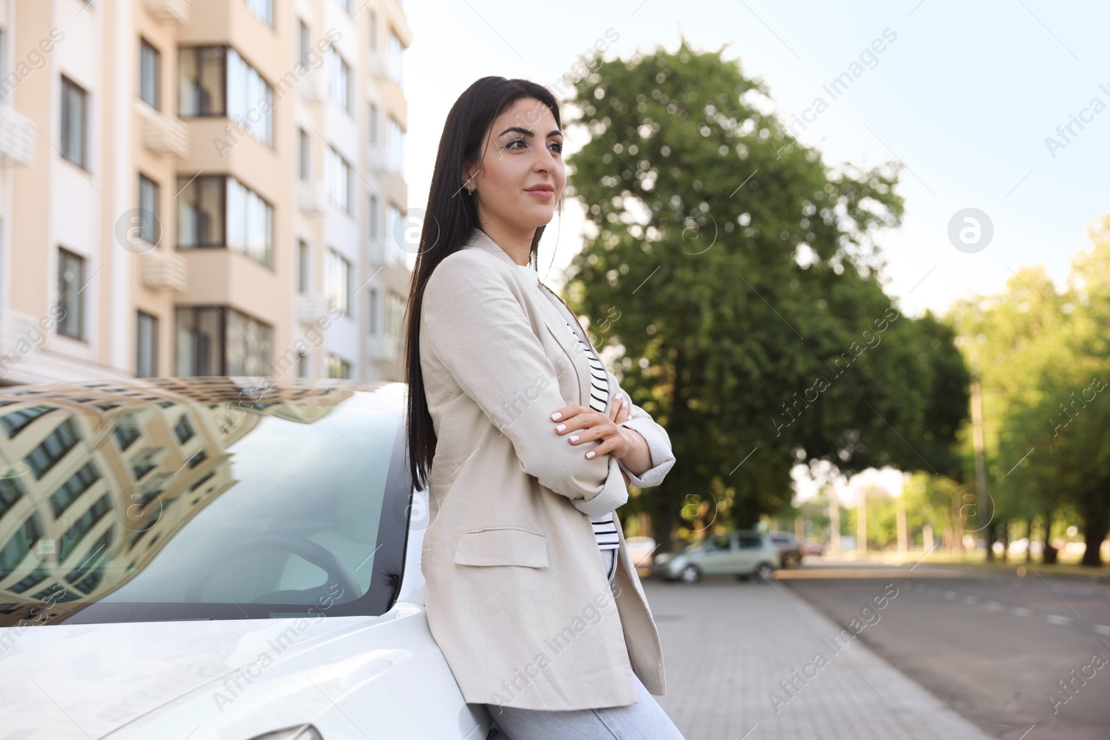 Beautiful woman near white car on city street Photo of Beautiful woman near white car on city street