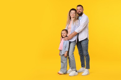 Photo of Happy family on yellow background. Space for text