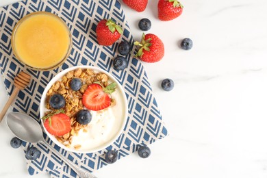 Photo of Tasty yogurt with granola, berries and honey on white marble table, flat lay. Space for text