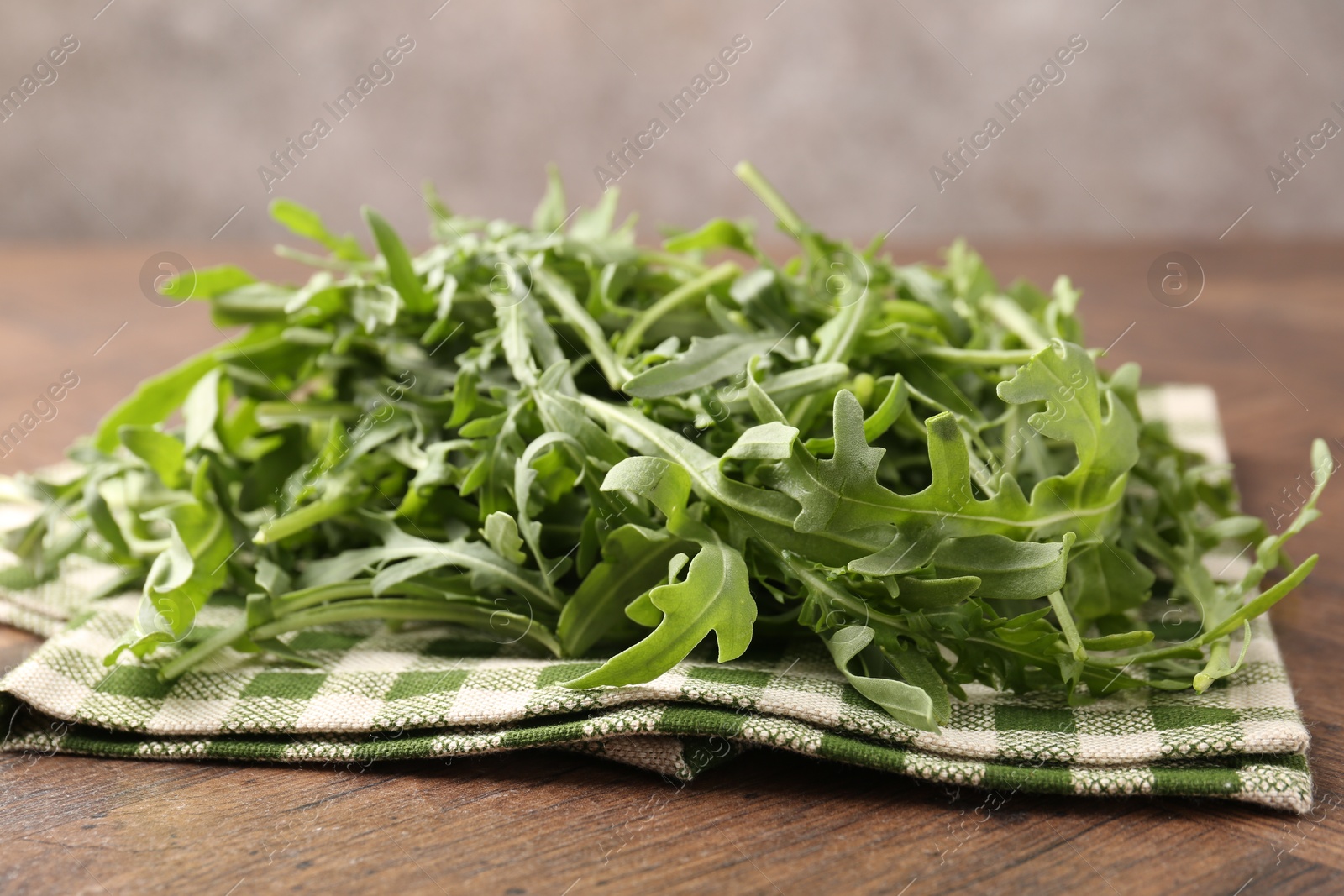 Fresh ripe green arugula leaves on wooden table, closeup Photo of Fresh ripe green arugula leaves on wooden table, closeup