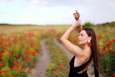 Photo of Beautiful woman posing in wildflower meadow. Space for text