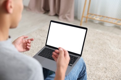 Photo of Man having online consultation with doctor via laptop at home, closeup