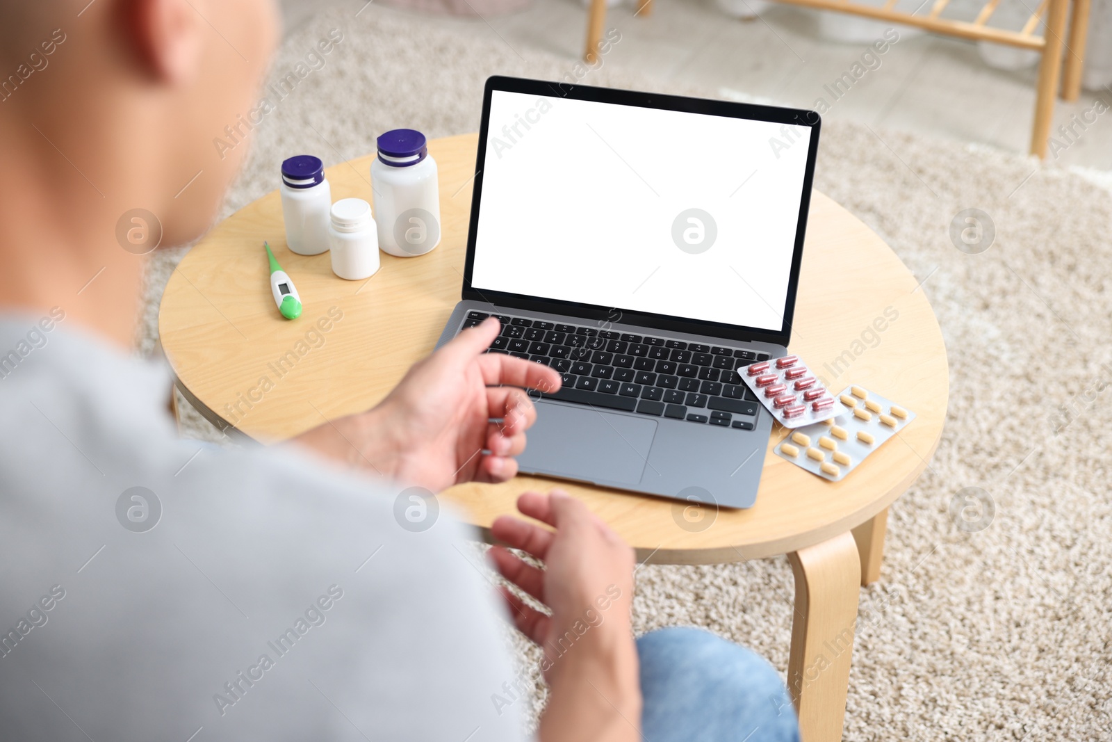 Man having online consultation with doctor via laptop at home, above view Photo of Man having online consultation with doctor via laptop at home, above view