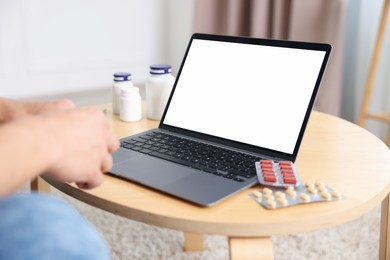 Photo of Man having online consultation with doctor via laptop at home, closeup