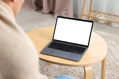 Photo of Man having online consultation with doctor via laptop at home, closeup