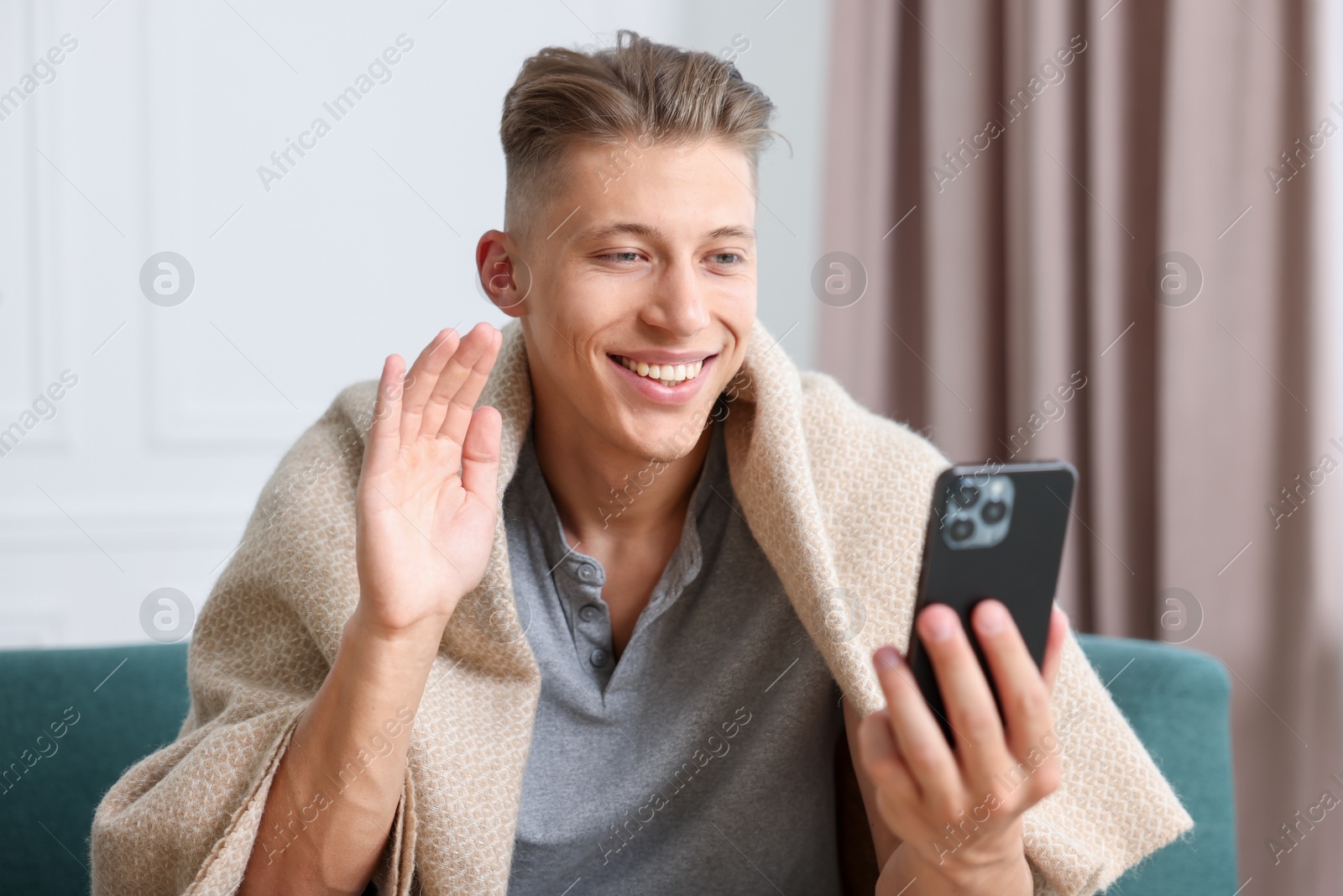 Man having online consultation with doctor via smartphone at home Photo of Man having online consultation with doctor via smartphone at home