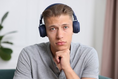 Photo of Man in headphones having online consultation with doctor at home