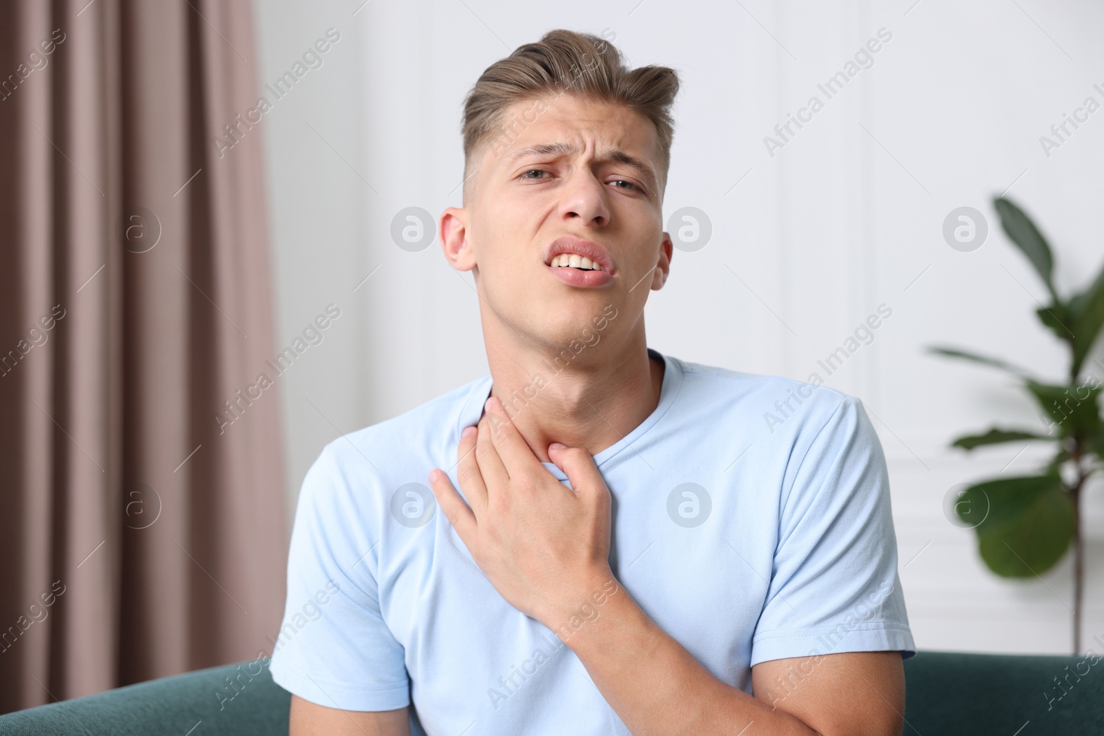 Portrait of sad man on sofa at home. Online medical consultation Photo of Portrait of sad man on sofa at home. Online medical consultation