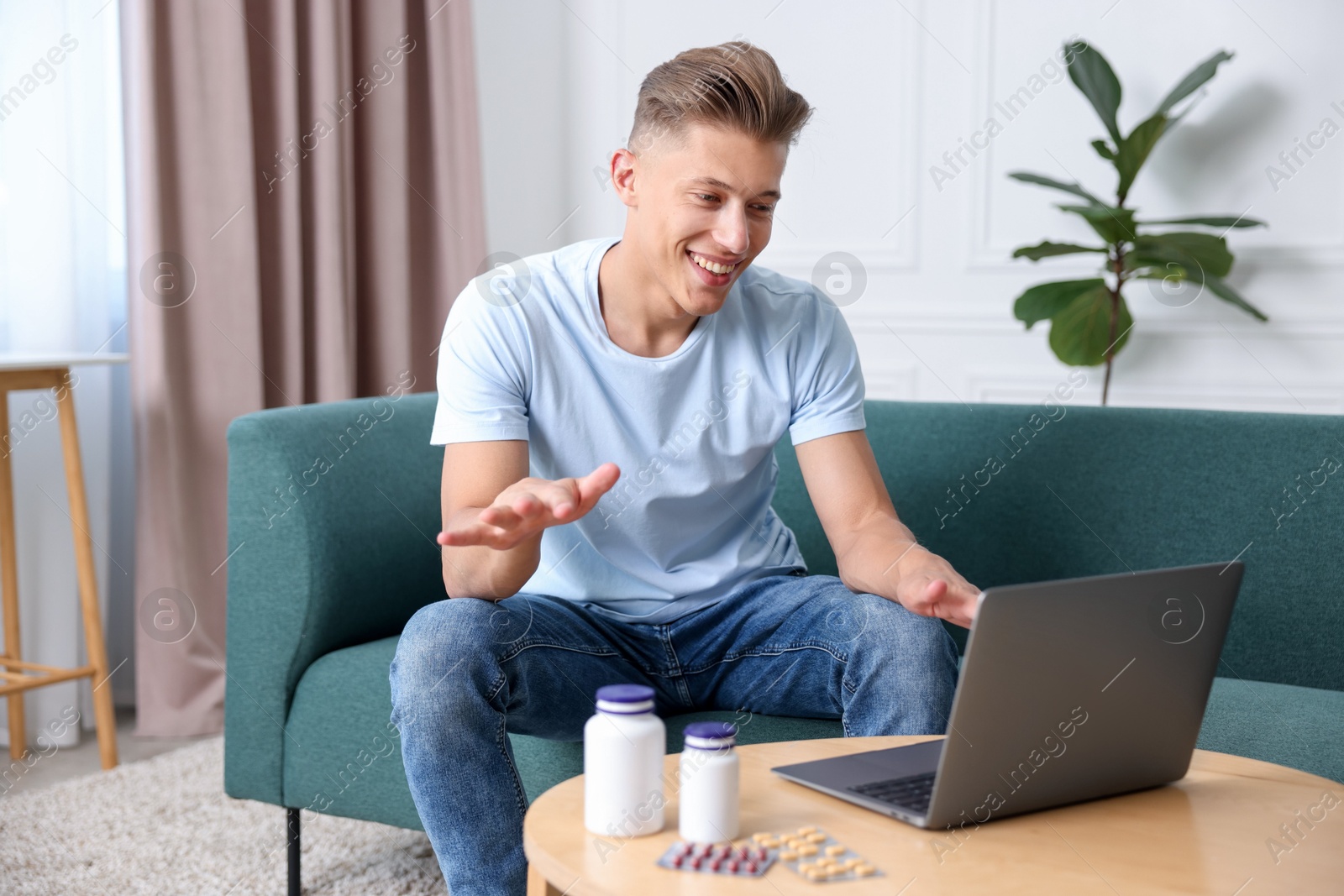 Man showing thumbs up while having online consultation with doctor via laptop at home Photo of Man showing thumbs up while having online consultation with doctor via laptop at home