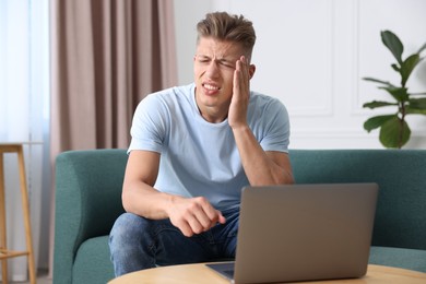 Photo of Sick man having online consultation with doctor via laptop at home