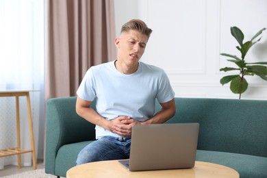 Photo of Sick man having online consultation with doctor via laptop at home