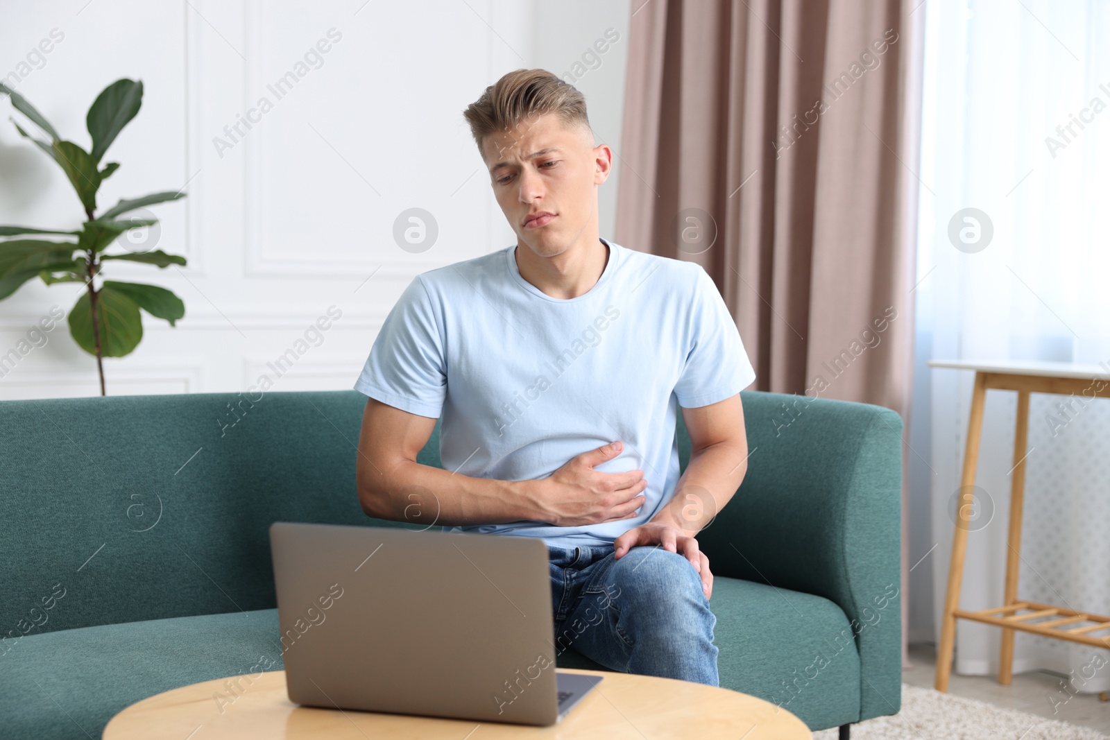 Photo of Sick man having online consultation with doctor via laptop at home
