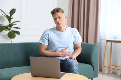 Photo of Sick man having online consultation with doctor via laptop at home