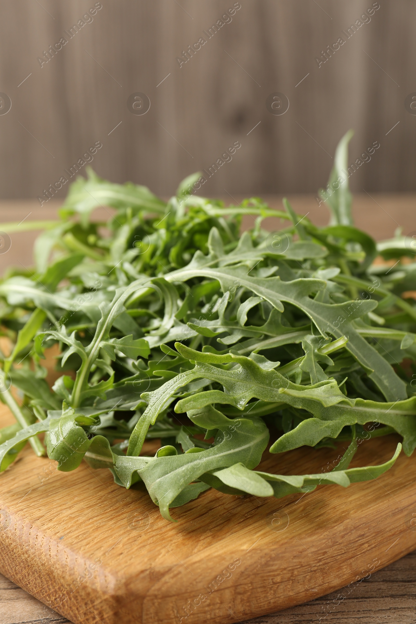 Fresh ripe green arugula leaves on table, closeup Photo of Fresh ripe green arugula leaves on table, closeup