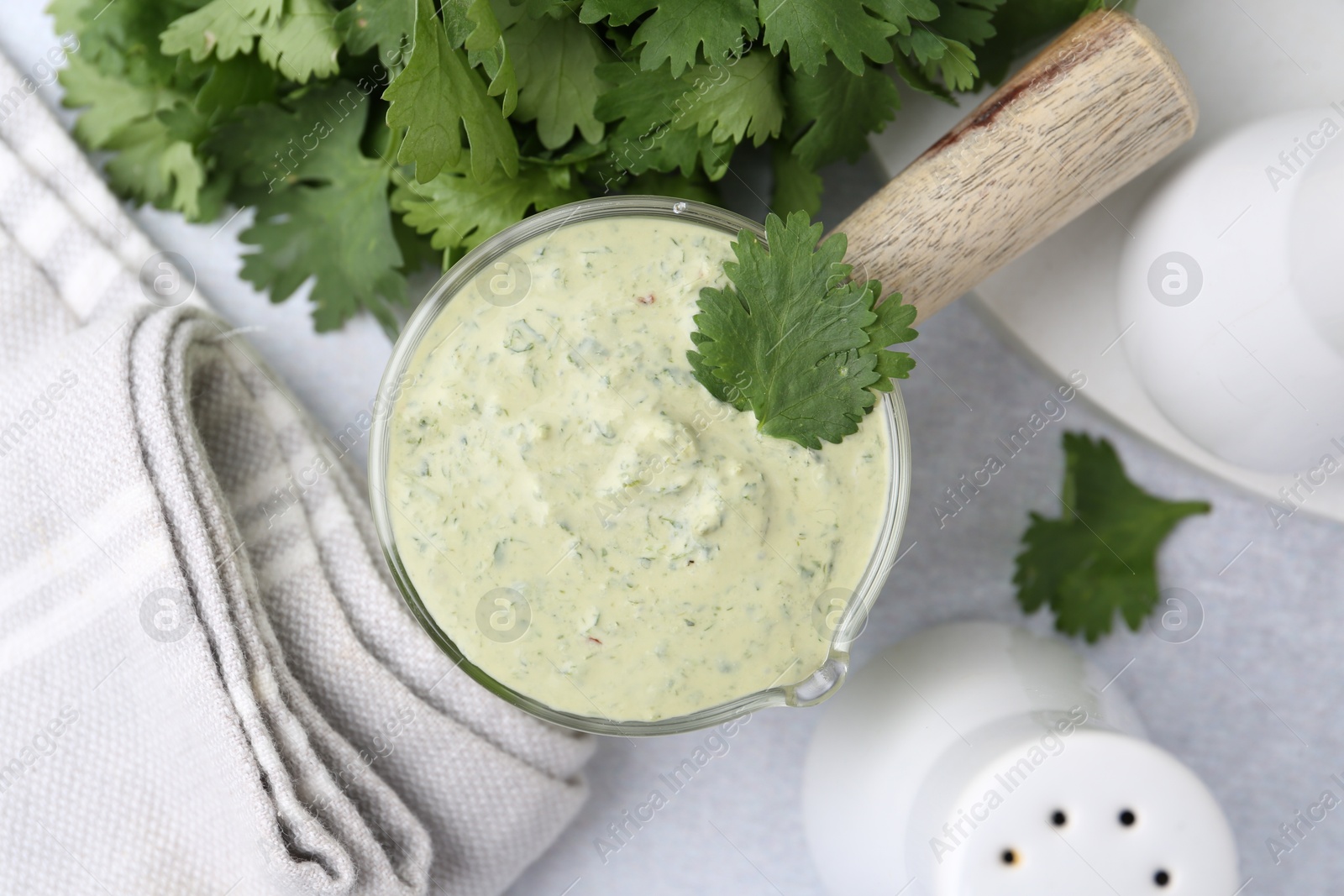 Tasty cilantro sauce on grey table, flat lay Photo of Tasty cilantro sauce on grey table, flat lay