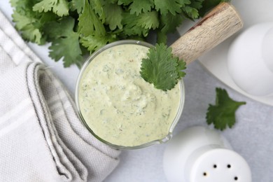 Photo of Tasty cilantro sauce on grey table, flat lay