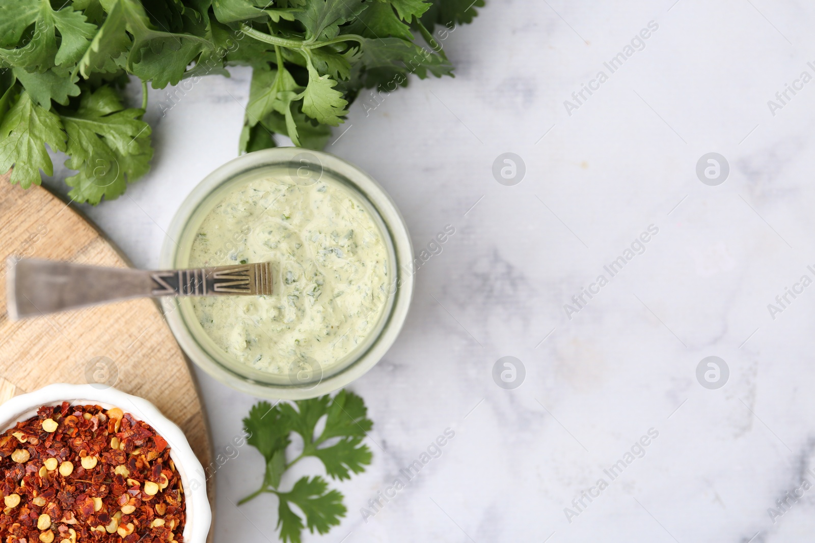 Tasty cilantro sauce and spices on light marble table, flat lay. Space for text Photo of Tasty cilantro sauce and spices on light marble table, flat lay. Space for text