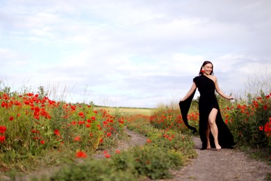 Photo of Smiling woman running in beautiful wildflower meadow
