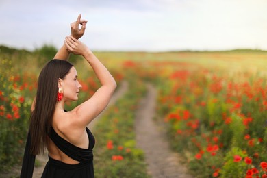 Photo of Beautiful woman posing in wildflower meadow. Space for text