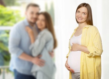 Image of Surrogate mother and intended parents indoors, selective focus