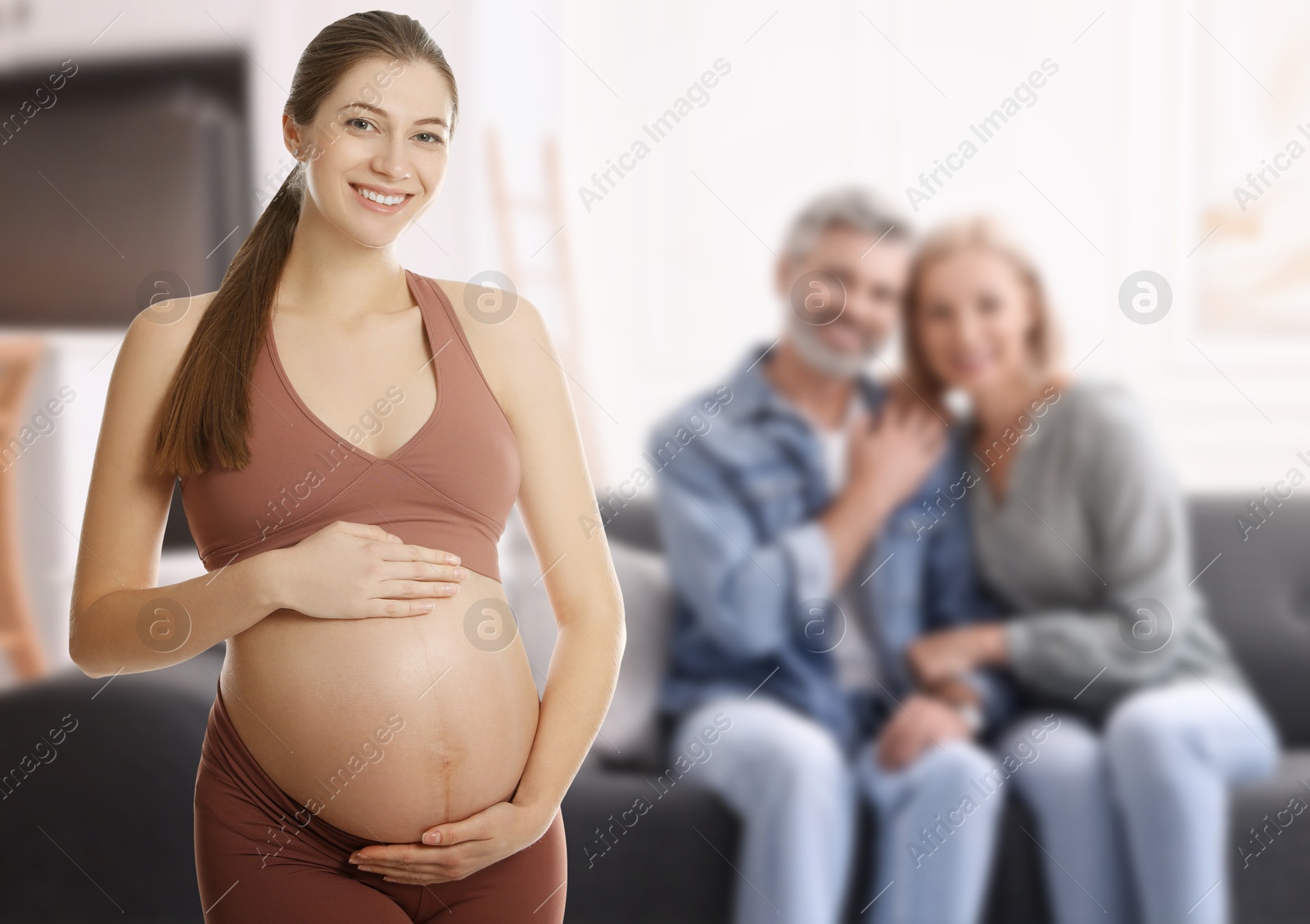 Image of Surrogate mother and intended parents indoors, selective focus