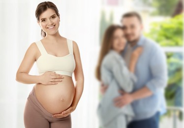 Image of Surrogate mother and intended parents indoors, selective focus