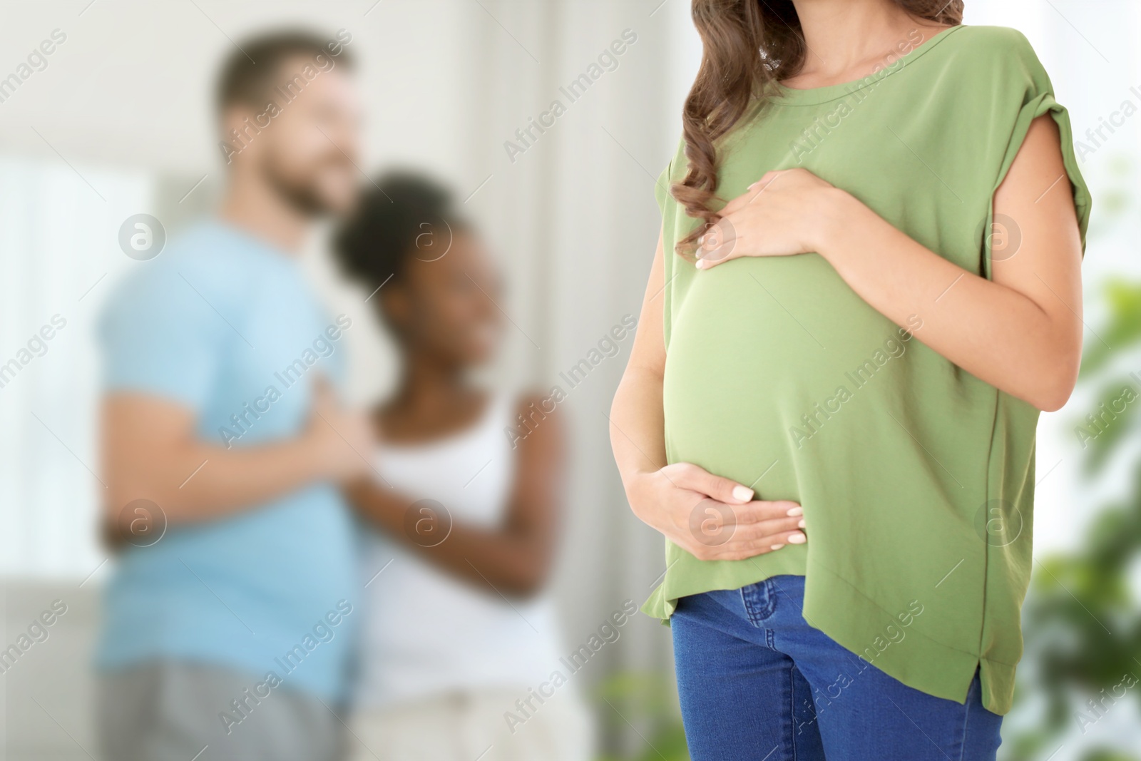 Surrogate mother and intended parents indoors, selective focus Image of Surrogate mother and intended parents indoors, selective focus