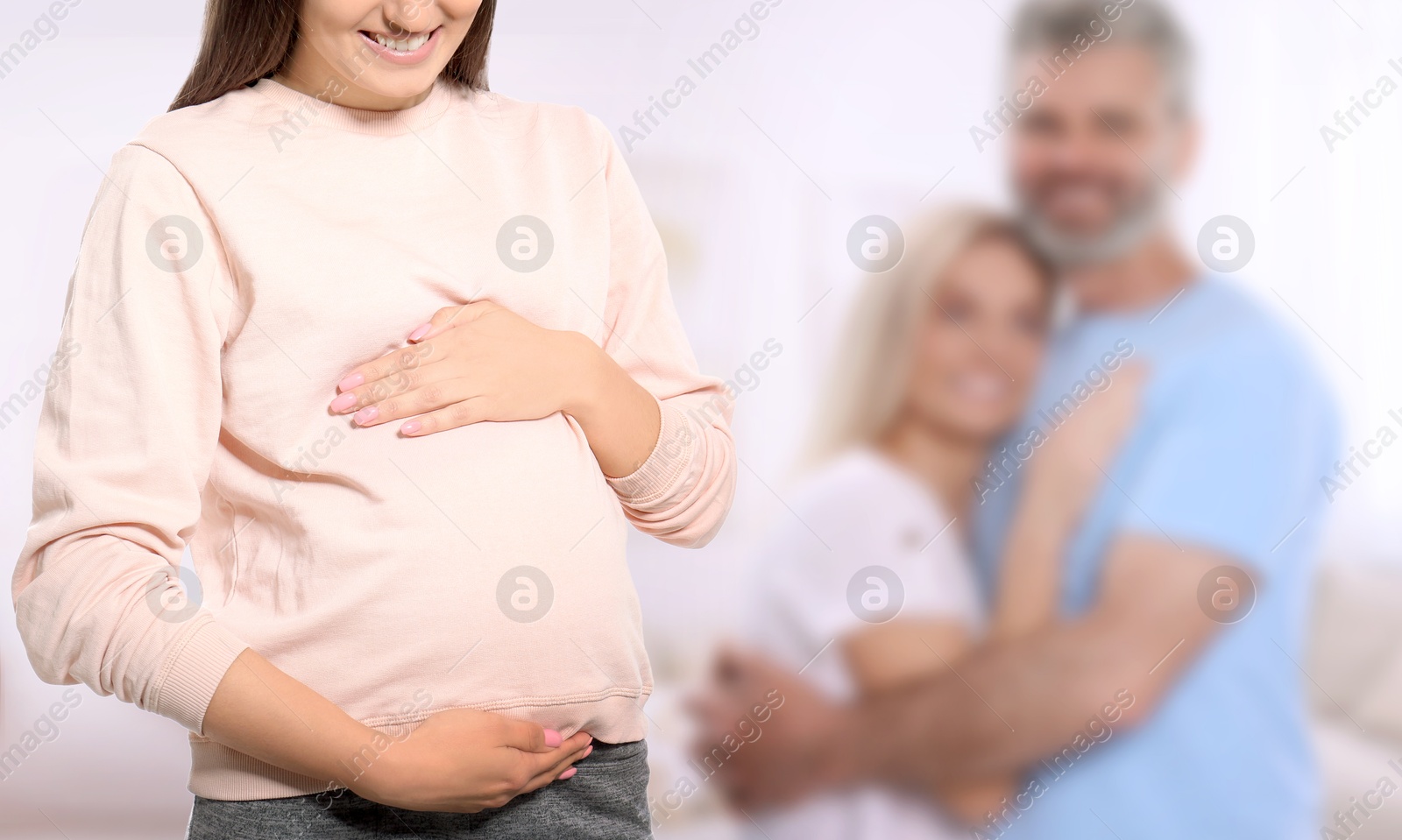 Surrogate mother and intended parents indoors, selective focus Image of Surrogate mother and intended parents indoors, selective focus