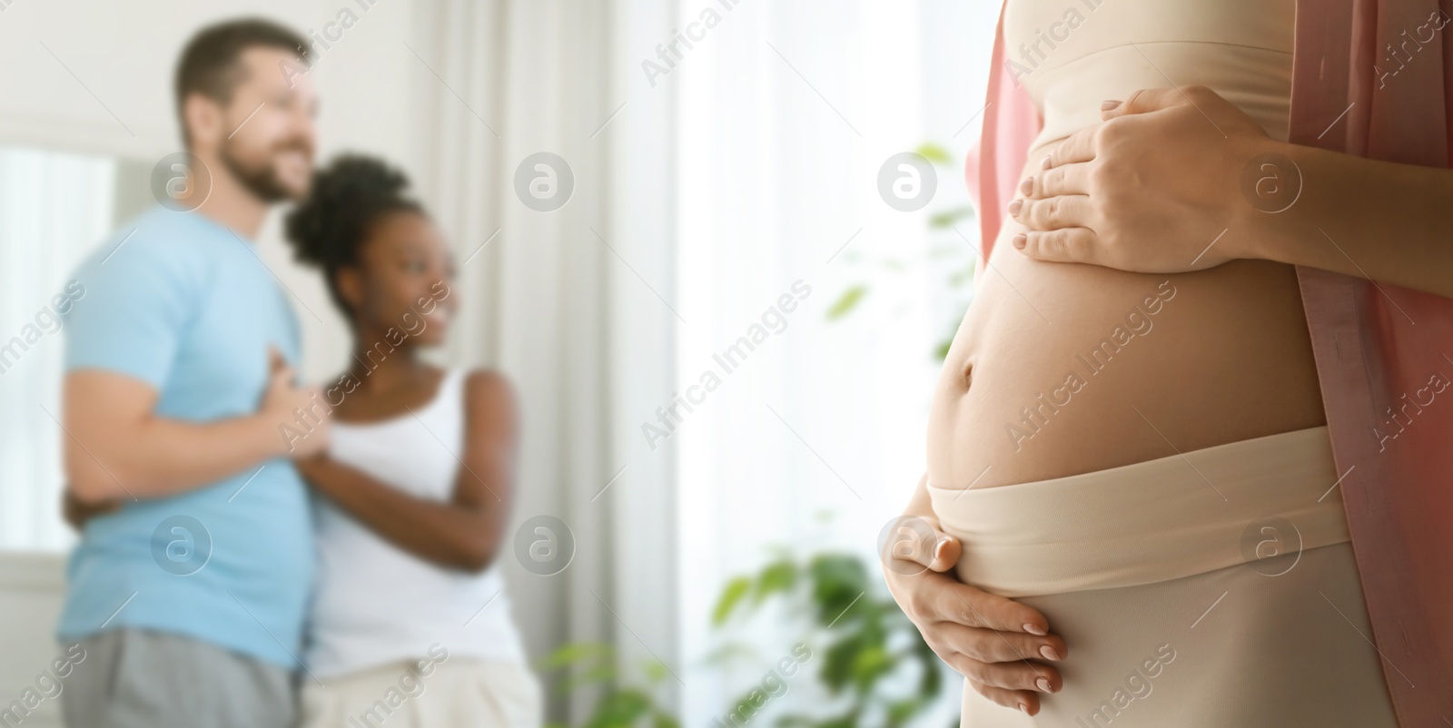 Surrogate mother and intended parents indoors, selective focus Image of Surrogate mother and intended parents indoors, selective focus