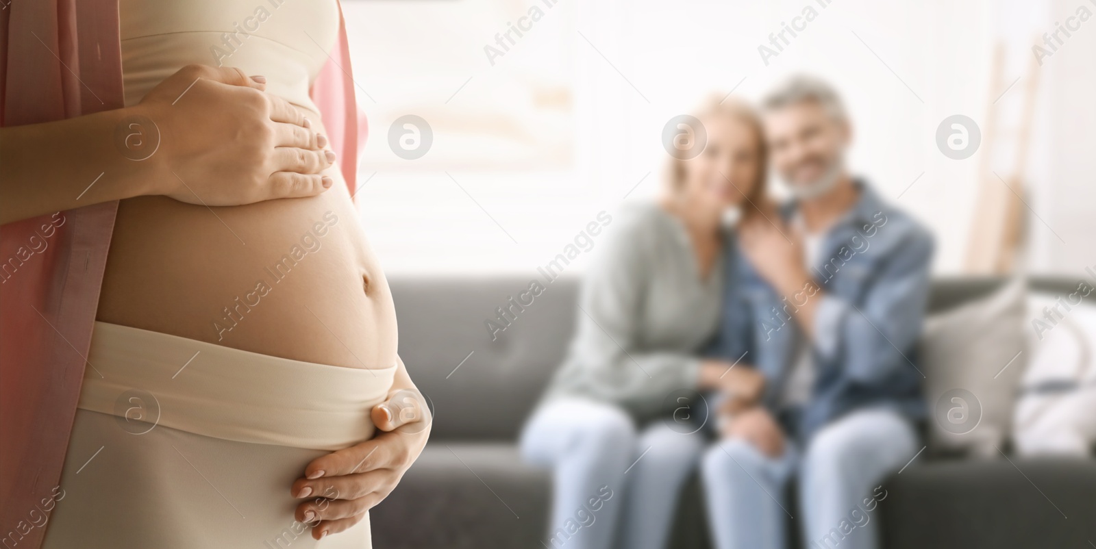 Image of Surrogate mother and intended parents indoors, selective focus
