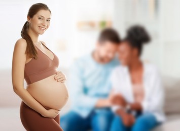 Image of Surrogate mother and intended parents indoors, selective focus