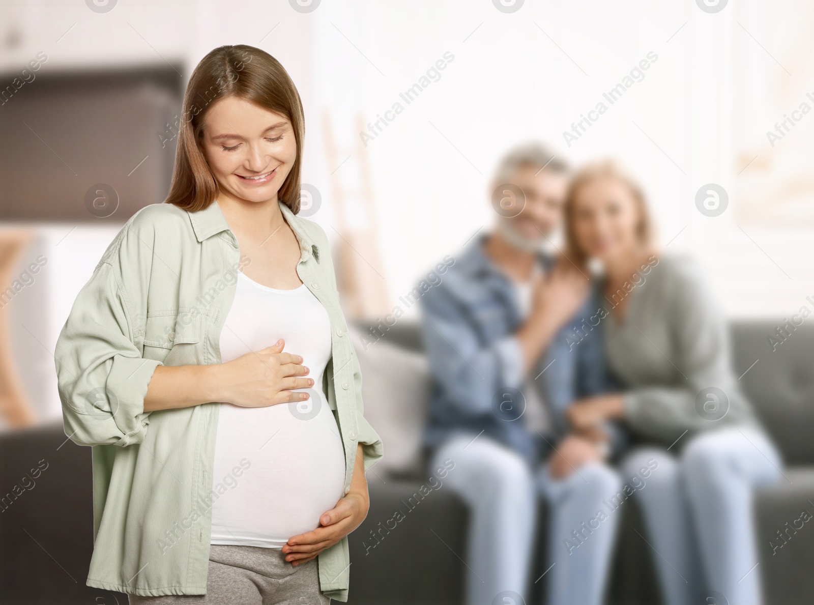 Image of Surrogate mother and intended parents indoors, selective focus