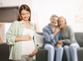 Image of Surrogate mother and intended parents indoors, selective focus
