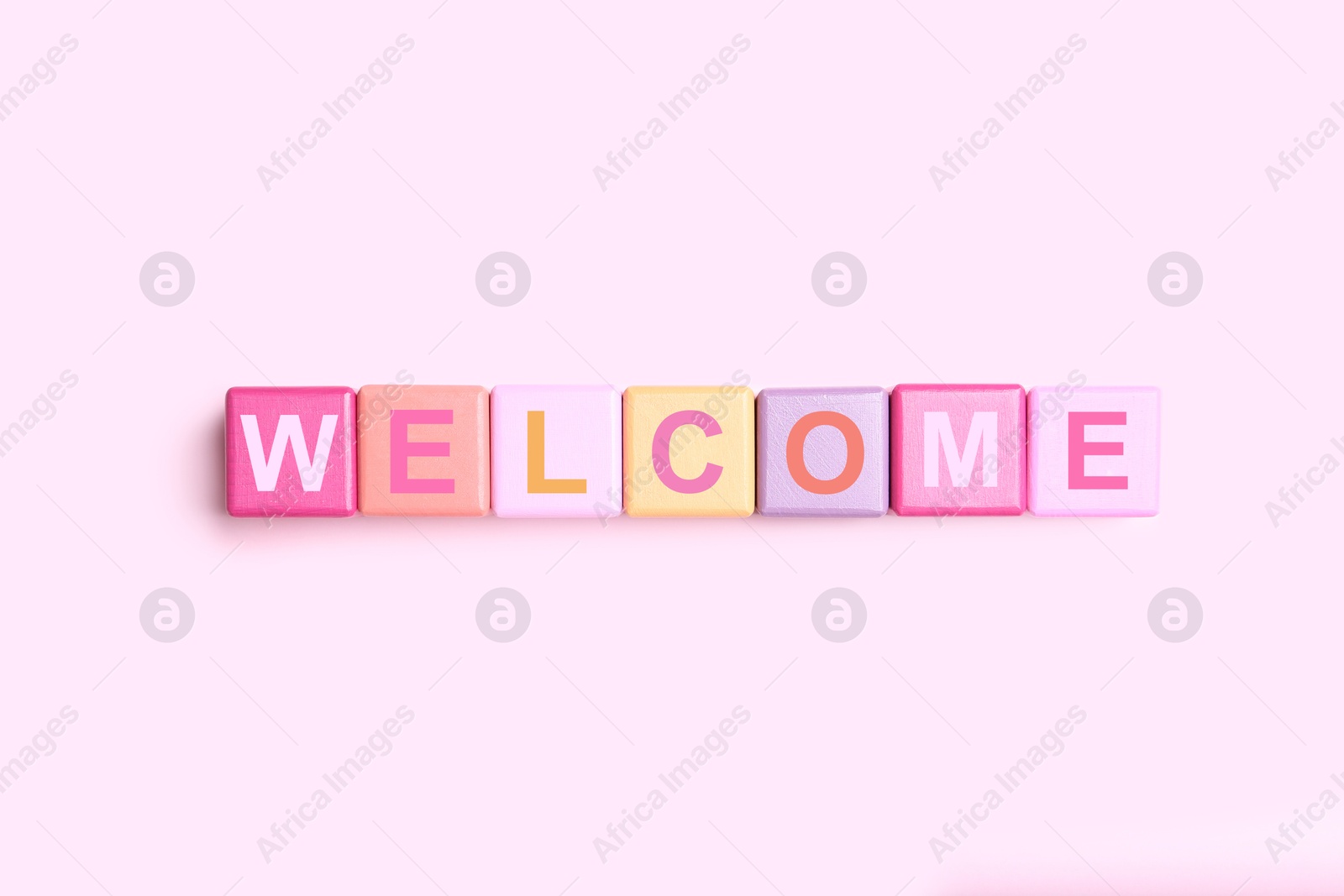 Word Welcome made of colorful cubes on pink background, top view Image of Word Welcome made of colorful cubes on pink background, top view