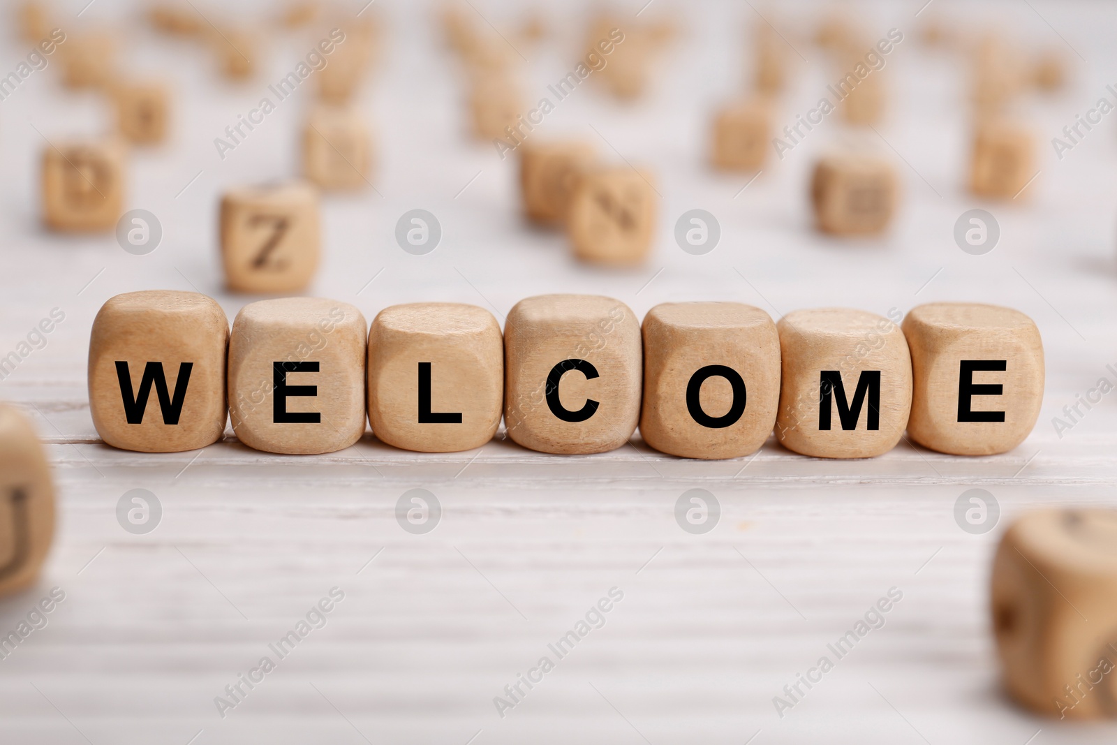 Word Welcome made of wooden cubes on white table, closeup Image of Word Welcome made of wooden cubes on white table, closeup
