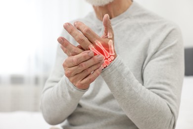 Image of Arthritis. Senior man suffering from pain in hand indoors, closeup. Illustration of joint inflammation