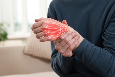 Image of Arthritis. Man suffering from pain in hand indoors, closeup. Illustration of joint inflammation