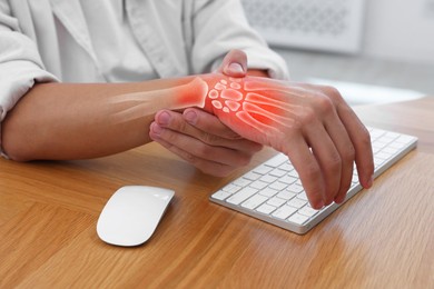 Image of Arthritis. Man suffering from wrist pain at table indoors, closeup. Illustration of joint inflammation on his hand