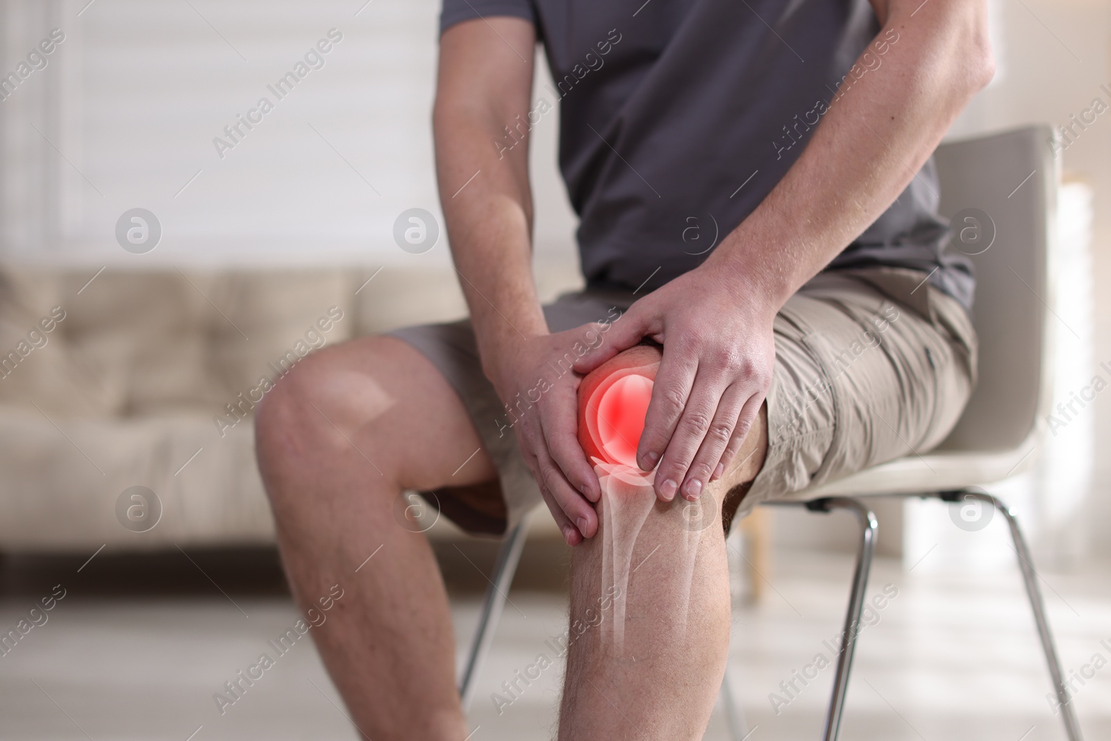 Arthritis. Man suffering from knee pain indoors, closeup. Illustration of joint inflammation on his leg Image of Arthritis. Man suffering from knee pain indoors, closeup. Illustration of joint inflammation on his leg