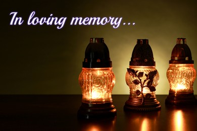 Image of In loving memory. Glowing grave lights on table in darkness