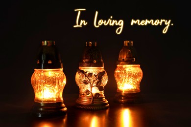 Image of In loving memory. Glowing grave lights on table in darkness
