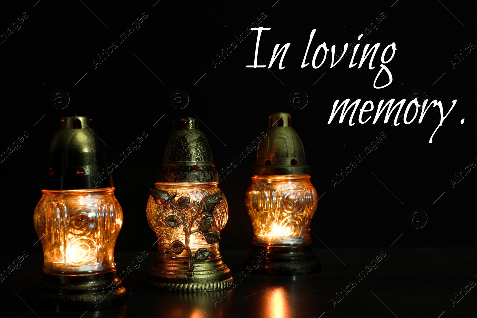 In loving memory. Glowing grave lights on table in darkness Image of In loving memory. Glowing grave lights on table in darkness